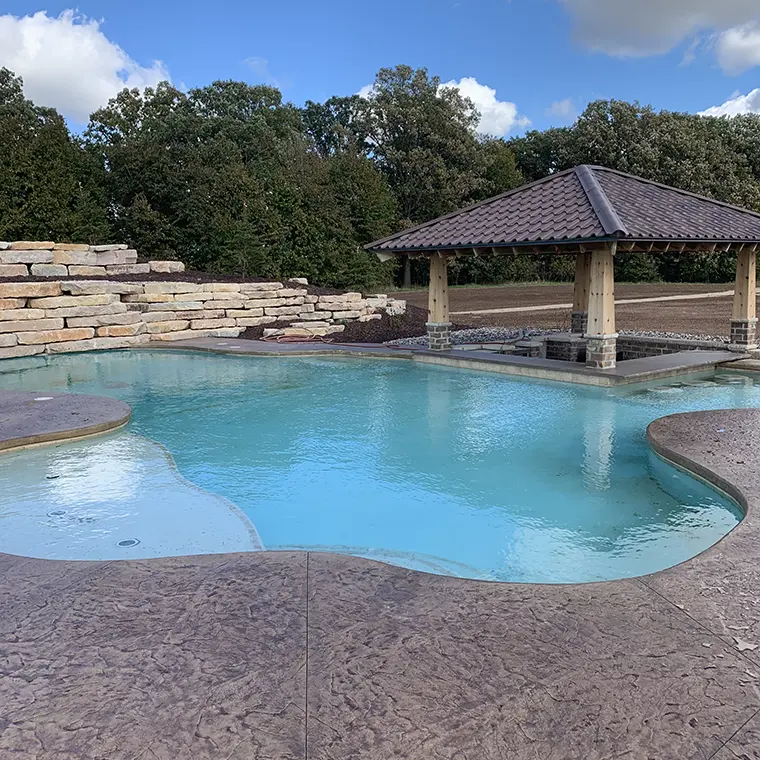 Pool with buried fire pit with pergola cover