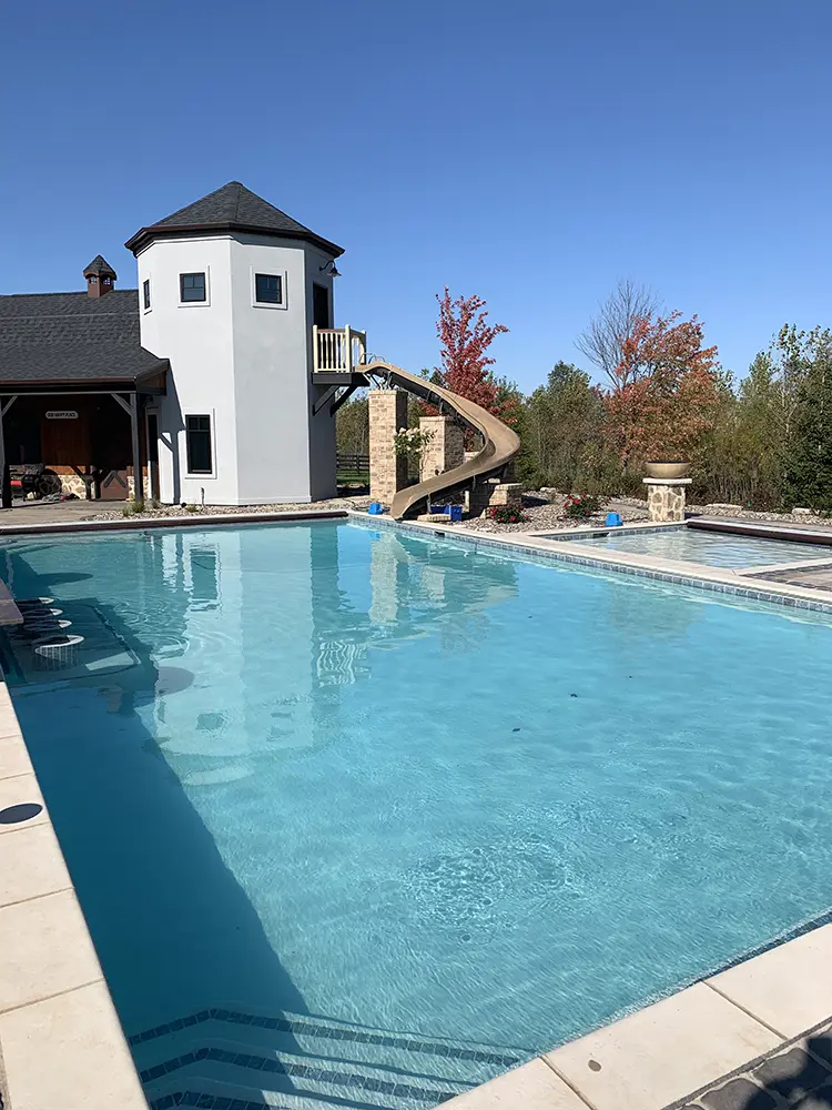 large rectangle pool with tan slide